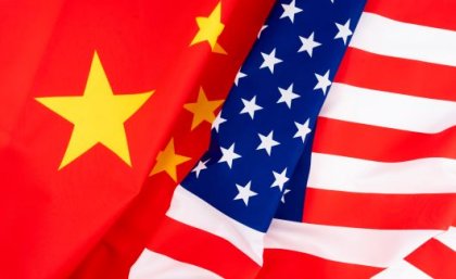 Image: Adobe. The Chinese and American flags side by side.